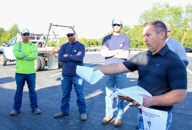 lineworkers going over a tailgate meeting before heading to south carolina